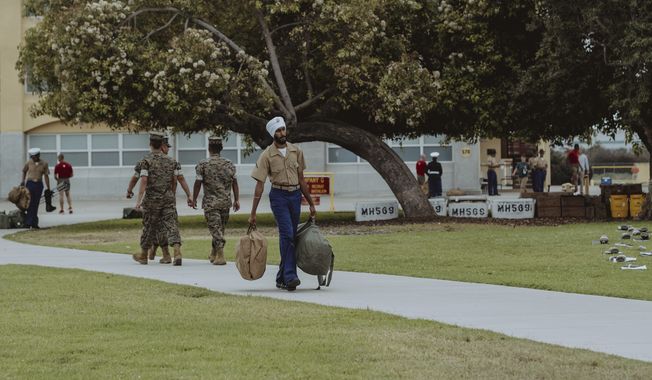 Marine Corps PFC Jaskirat Singh, age 21, carries his belongings after completing recruit training at the Marine Corps Recruit Depot in San Diego, California, on Friday, August 11, 2023. A Houston resident, he is the first Sikh to complete basic training while retaining his beard, turban and other “articles of faith.” (Sikh Coalition photo, used with permission)