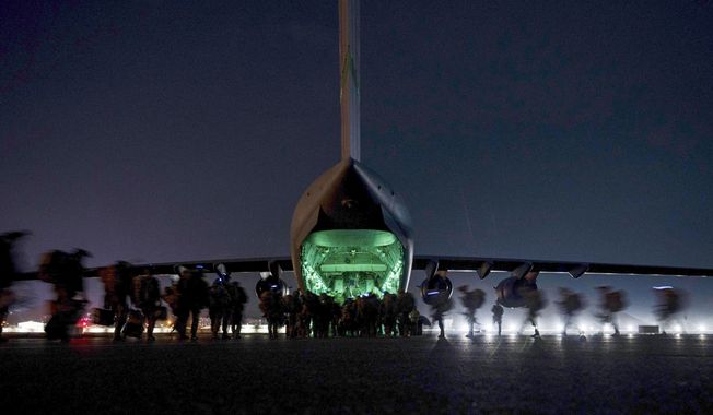 In this Aug. 30, 2021, file photo provided by the U.S. Air Force, soldiers, assigned to the 82nd Airborne Division, prepare to board a U.S. Air Force C-17 Globemaster III aircraft at Hamid Karzai International Airport in Kabul, Afghanistan. A State Department report says the department failed to do enough contingency planning before the collapse of the U.S.-backed government in Afghanistan. The review repeatedly blames the administration of former President Donald Trump for not doing enough planning or processing of visas after beginning the withdrawal. (Senior Airman Taylor Crul/U.S. Air Force via AP, File)