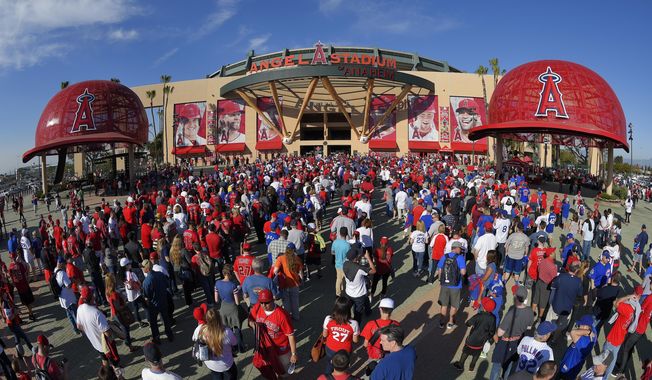 Fans line up outside Angel Stadium of Anaheim for an opening day baseball game between the Los Angeles Angels and the Chicago Cubs in Anaheim, Calif., on April 4, 2016. Harish Singh Sidhu, the former mayor of the Southern California city of Anaheim has agreed to plead guilty to obstructing an FBI corruption investigation into the $150 million sale of Angel Stadium to the owner of the Major League Baseball team, federal prosecutors announced Wednesday, Aug. 16, 2023. (AP Photo/Mark J. Terrill, File)
