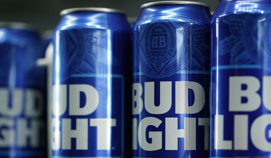 Cans of Bud Light beer are seen before a baseball game between the Philadelphia Phillies and the Seattle Mariners on April 25, 2023, in Philadelphia. Anheuser-Busch InBev has reported a drop in U.S. revenue in the second quarter as Bud Light sales plunged amid conservative backlash over a campaign with transgender influencer Dylan Mulvaney. (AP Photo/Matt Slocum) **FILE**