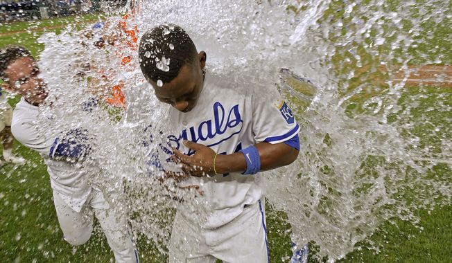 Kansas City Royals&#x27; Freddy Fermin, left, douses Dairon Blanco after their baseball game against the Seattle Mariners Monday, Aug. 14, 2023, in Kansas City, Mo. The Royals won 7-6. (AP Photo/Charlie Riedel)