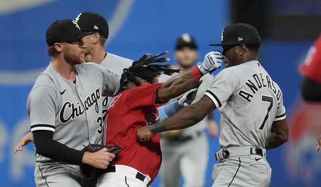Cleveland Guardians&#x27; Jose Ramirez, center, and Chicago White Sox&#x27;s Tim Anderson (7) exchange punches in the sixth inning of a baseball game Saturday, Aug. 5, 2023, in Cleveland. White Sox&#x27;s Michael Kopech, left looks on. (AP Photo/Sue Ogrocki) **FILE**