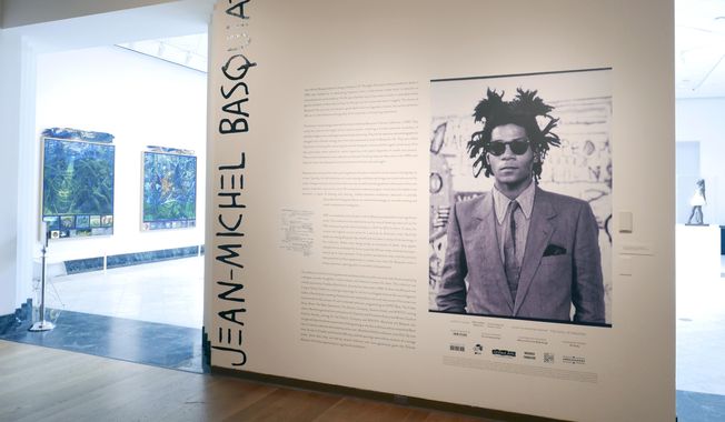 The entrance to an exhibit by artist Jean-Michel Basquiat is seen at the Orlando Museum of Art, June 1, 2022, in Orlando, Fla. On Monday, Aug. 14, 2023, the central Florida art museum which was raided last year by the FBI over an exhibit of what turned out to be forged Jean-Michel Basquiat paintings filed suit against its former executive director and others, claiming they were part of a plan to profit from the sale of the fake artwork. (AP Photo/John Raoux, File)