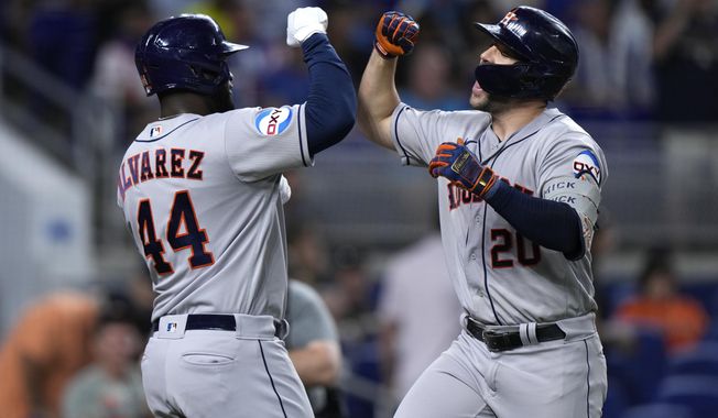 Houston Astros&#x27; Chas McCormick (20) celebrates with Houston Astros&#x27; Yordan Alvarez (44) after McCormick hit a home run scoring Alvarez during the first inning of a baseball game against the Miami Marlins, Wednesday, Aug. 16, 2023, in Miami. (AP Photo/Wilfredo Lee)