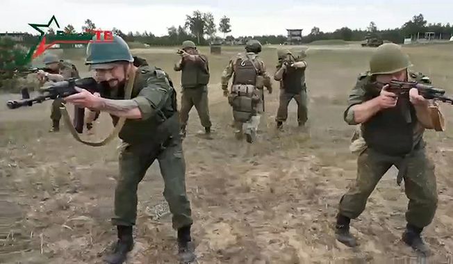 In this photo taken from video released by Belarusian Defense Ministry via VoenTV on Friday, July 14, 2023, Belarusian soldiers attend a training by mercenary fighters from Wagner private military company near Tsel village, about 55 miles southeast of Minsk, Belarus. Thousands of Russia-linked Wagner group mercenaries have arrived in Belarus since the group&#x27;s short-lived rebellion, a military monitoring group said Monday. (Belarusian Defense Ministry via VoenTV via AP, File)