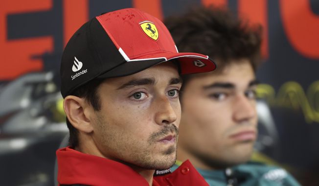 Ferrari driver Charles Leclerc of Monaco, left, during a media conference ahead of the Formula One Grand Prix at the Spa-Francorchamps racetrack in Spa, Belgium, Thursday, July 27, 2023. The Belgian Formula One Grand Prix will take place on Sunday. (AP Photo/Geert Vanden Wijngaert)