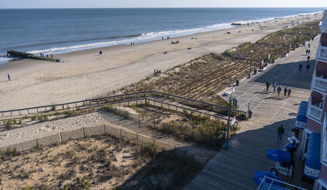 In this file photo, the beach and boardwalk are seen, Friday, Nov. 13, 2020, in Rehoboth Beach, Del. President Joe Biden owns a $2.7 million, Delaware North Shores home with a swimming pool that overlooks Cape Henlopen State Park, is blocks from the ocean and a short drive from downtown Rehoboth Beach.  (AP Photo/Alex Brandon)