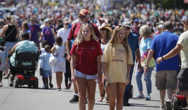 Thousands of fairgoers pack Grand Avenue during the Iowa State Fair on Friday, Aug. 13, 2021, in Des Moines, Iowa. (Bryon Houlgrave/The Des Moines Register via AP)
