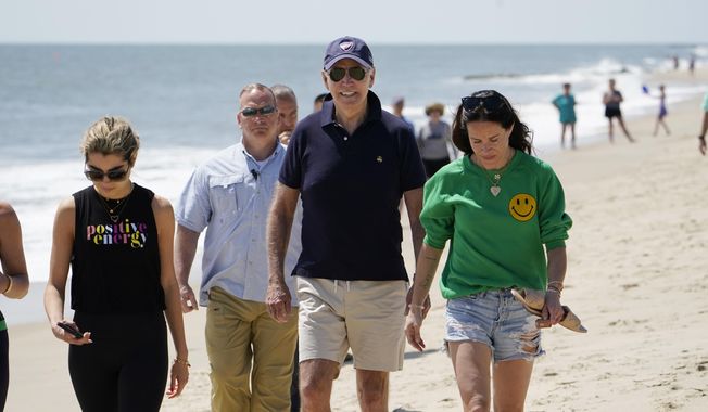 President Joe Biden walks on the beach with his granddaughter Natalie Biden, left, and his daughter Ashley Biden, right, Monday, June 20, 2022, at Rehoboth Beach, Del. The president spent all or part of 197 days in his home state of Delaware, traveling most weekends to either his home near Wilmington or his vacation home at Rehoboth Beach, according to an AP tally. (AP Photo/Manuel Balce Ceneta, File)