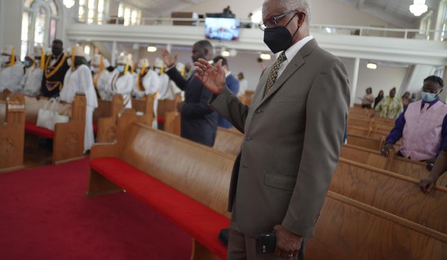Herbert Barnette, deacon at Zion Baptist Church, bows his head in prayer, during service on Sunday, April 16, 2023, in Columbia, S.C. Barnette says there is still a fear of COVID and that he will continue to wear a mask and social distance himself when attending church in person. (AP Photo/Jessie Wardarski)