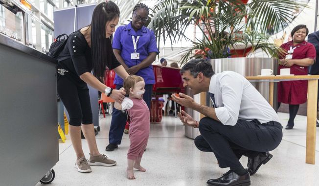 Prime Minister Rishi Sunak visits the Evelina Children&#x27;s ward at St Thomas&#x27; hospital to take part in a NHS Big Tea celebration to mark the 75th anniversary of the NHS, in central London, Tuesday July 4, 2023.. (Jack Hill/Pool Photo via AP)