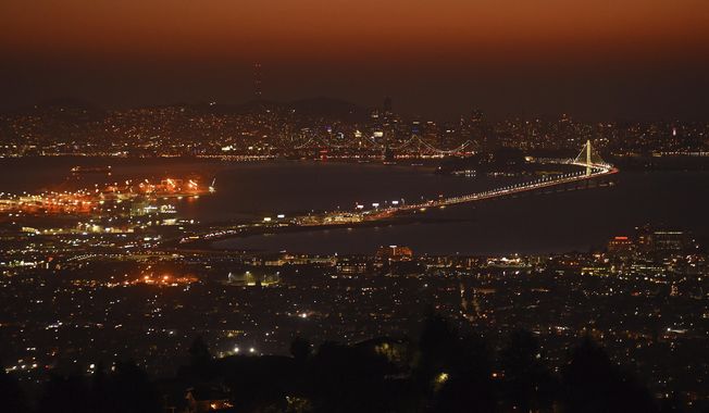 Traffic moves steadily on the Bay Bridge as the Bay Area braces for possible high winds as seen from Grizzly Peak Boulevard in Oakland, Calif., Sunday, Oct. 25, 2020. Due to high winds and dry conditions PG&amp;amp;E will turn off the power to over 361,000 customers in 36 counties to protect them from possible wildfires caused by downed power lines. The National Weather Service predicts offshore winds from the north peaking at higher elevations up to 70 mph. (Jose Carlos Fajardo/Bay Area News Group via AP)