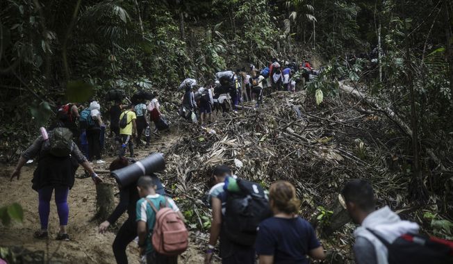 Migrants walk across the Darien Gap from Colombia to Panama in hopes of reaching the U.S., May 9, 2023. (AP Photo/Ivan Valencia, File)