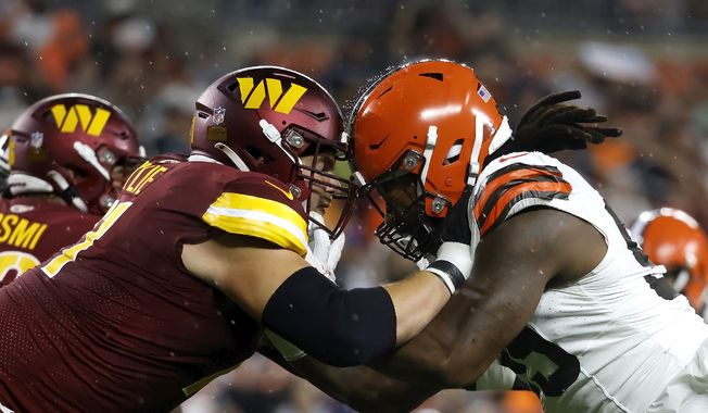 Washington Commanders guard Andrew Wylie (71) blocks Cleveland Browns defensive end Za&#x27;Darius Smith (99) during an NFL pre-season football game, Friday, Aug. 11, 2023, in Cleveland. (AP Photo/Kirk Irwin) **FILE**