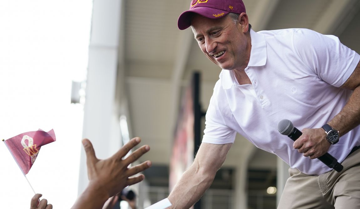 Josh Harris, the leader of a group buying the Washington Commanders, greets fans during an NFL football pep rally at FedEx Field in Landover, Md., Friday, July 21, 2023. (AP Photo/Stephanie Scarbrough)