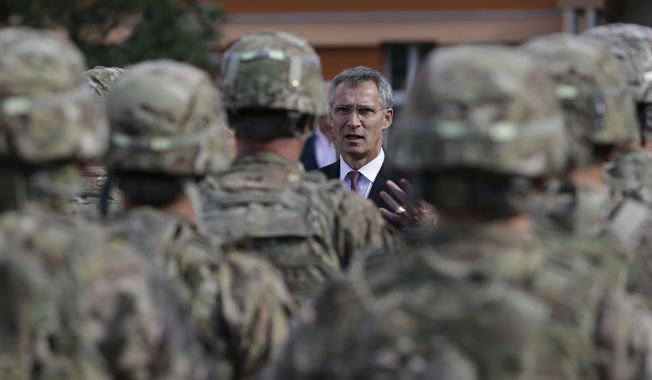 NATO Secretary-General Jens Stoltenberg talks to U.S. army soldiers while visiting Prague, Czech Republic, on Sept. 9, 2015. The Czech Republic has completed the ratification of a defense treaty with the United States that deepens military cooperation and makes it easier to deploy U.S. troops on Czech territory. Czech Prime Minister Petr Fiala&#x27;s signature on Wednesday, Aug. 16, 2023, was the final step in the ratification process of the Defense Cooperation Agreement. (AP Photo/Petr David Josek, File)