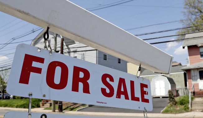 FILE - A &amp;quot;for sale&amp;quot; sign hangs from a post outside of a vacant business building in Belleville, N.J., Thursday, May 3, 2018.  The Federal Reserve on Wednesday, July 27,  raised its benchmark interest rate by a hefty three-quarters of a point for a second straight time in its most aggressive drive in three decades to tame high inflation.  By raising borrowing rates, the Fed makes it costlier to take out a mortgage or an auto or business loan.(AP Photo/Julio Cortez, File)