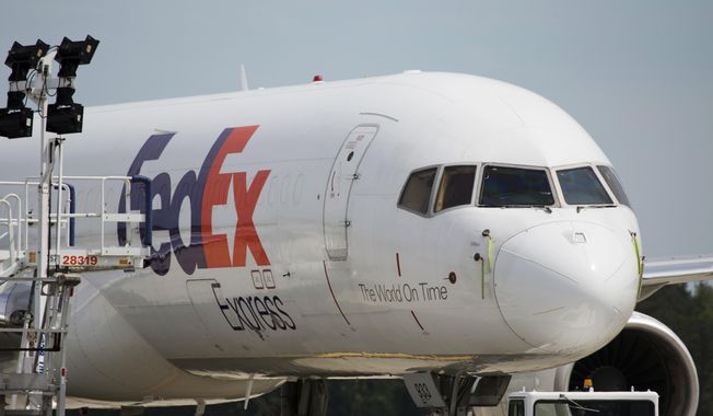 In this April 18, 2017, file photo, a FedEx cargo plane sits idle during the day at Richmond International Airport in Sandston, Va. (AP Photo/Steve Helber, File)