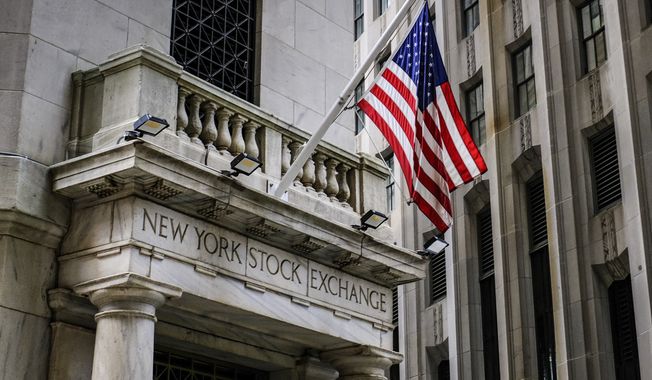 The U.S. flag flies over the side entrance to the New York Stock Exchange in New York Tuesday, July 18, 2023. (AP Photo/J. David Ake) ** FILE **