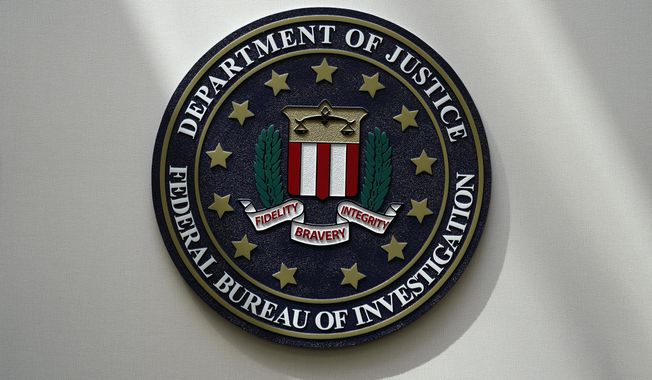 The FBI seal is pictured in Omaha, Neb., Aug. 10, 2022. A White House advisory board is calling for major changes in how the FBI uses a controversial foreign surveillance tool. The President’s Intelligence Advisory Board issued a report Monday, July 31, 2023, with new recommendations related to Section 702 of the Foreign Intelligence Surveillance Act. (AP Photo/Charlie Neibergall, File)