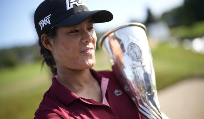 France&#x27;s Celine Boutier poses with her trophy after winning the Evian Championship women&#x27;s golf tournament in Evian, eastern France, Sunday, July 30, 2023. (AP Photo/Lewis Joly)
