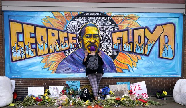 Damarra Atkins pays respect to George Floyd at a mural at George Floyd Square in Minneapolis, April 23, 2021. Tou Thao, the last former Minneapolis police officer to face sentencing in state court for his role in the killing of Floyd, will learn Monday, Aug. 7, 2023, whether he&#x27;ll spend any additional time in prison. (AP Photo/Julio Cortez, File)