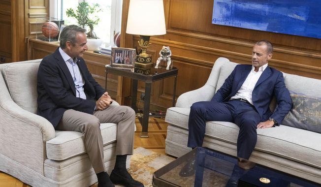 Greek Prime Minister Kyriakos Mitsotakis, left, meets with the UEFA President Aleksander Ceferin in Athens, on Wednesday, Aug. 16, 2023, in the wake of a deadly attack led by Croatian football supporters in the Greek capital. The meetings, to be joined by representatives from Greece&#x27;s four major clubs, were held hours before Greece hosts the annual UEFA Super Cup between Sevilla and Manchester City. in Athens, on Wednesday, Aug. 16, 2023.(AP Photo/Petros Giannakouris)