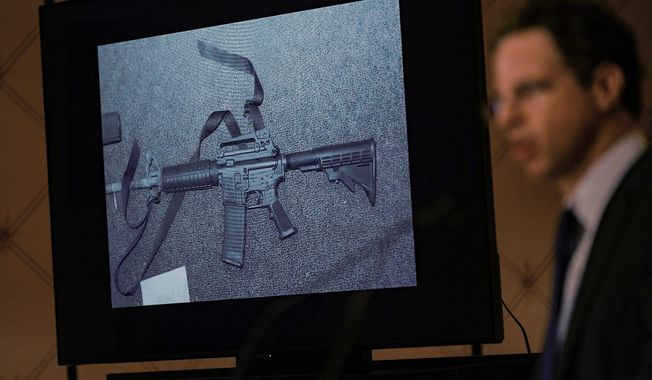 An image of the weapon used during the Newtown school shooting is displayed while attorney Josh Koskoff speaks during a news conference in Trumbull, Conn., Feb. 15, 2022. A federal judge on Thursday, Aug. 3, 2023, rejected a request to temporarily block Connecticut&#x27;s landmark 2013 gun control law, passed after the Sandy Hook Elementary School shooting, until a gun rights group&#x27;s lawsuit against the statute has concluded. (AP Photo/Seth Wenig, File)
