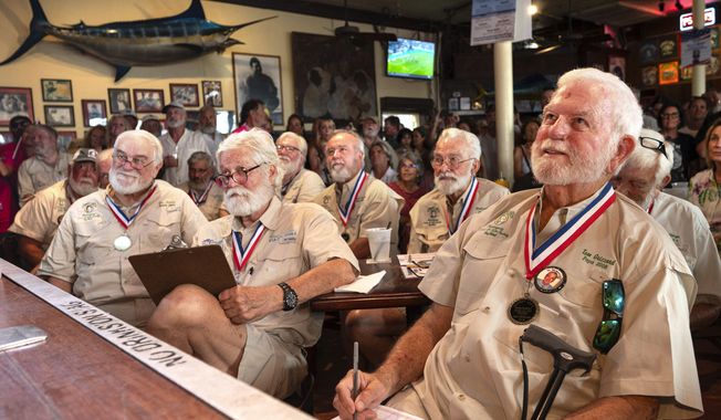 In this photo provided by the Florida Keys News Bureau, Tom Grizzard, right, winner of the 2008 &quot;Papa&quot; Hemingway Look-Alike Contest, and other past winners judge contestants during the 2023 contest, Thursday, July 20, 2023, at Sloppy Joe&#x27;s Bar in Key West. Almost 140 contestants are competing in the challenge, a featured event of Key West&#x27;s annual Hemingway Days festival that ends Sunday, July 23. Hemingway&#x27;s 124th birthday anniversary is Friday, July 21. The 2023 &quot;Papa&quot; is to be crowned Saturday, July 22. (Andy Newman/Florida Keys News Bureau via AP)