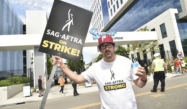 Adam Shapiro poses on a picket line outside Netflix studios on Tuesday, Aug. 1, 2023, in Los Angeles. The actors strike comes more than two months after screenwriters began striking in their bid to get better pay and working conditions. (Photo by Richard Shotwell/Invision/AP)