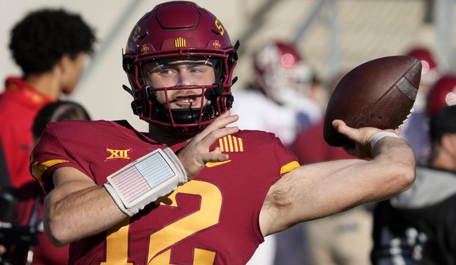 Iowa State quarterback Hunter Dekkers (12) warms up before an NCAA college football game against Oklahoma, Saturday, Oct. 29, 2022, in Ames, Iowa. Dekkers has been accused of gambling on Cyclone sports events, including a football game, and was charged Tuesday, Aug. 1, 2023, with tampering with records related to an Iowa Criminal Division investigation into sports gambling. (AP Photo/Charlie Neibergall, File)