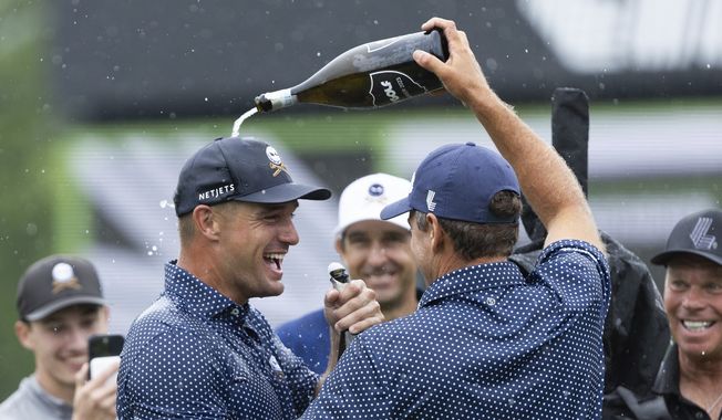 Captain Bryson DeChambeau, front left, of Crushers GC, and Charles Howell III, also of Crushers GC, celebrate on the 18th green during the final round of LIV Golf Greenbrier at The Old White at The Greenbrier, Sunday, Aug. 6, 2023 in White Sulfur Springs, W.Va. (Sam Greenwood/LIV Golf via AP)