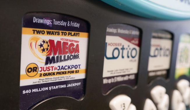 A Mega Millions logo is displayed on a vending machine at the Hoosier Lottery booth at the Indiana State Fair, Thursday, Aug. 3, 2023, in Indianapolis. (AP Photo/Darron Cummings)