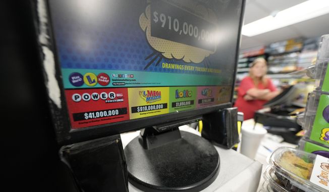 A display for the Mega Millions lottery is seen at the Save &#x27;N Time convenience store in Harahan, La., Wednesday, July 26, 2023. The Mega Millions lottery jackpot is approaching $1 billion ahead of Friday’s drawing. (AP Photo/Gerald Herbert)