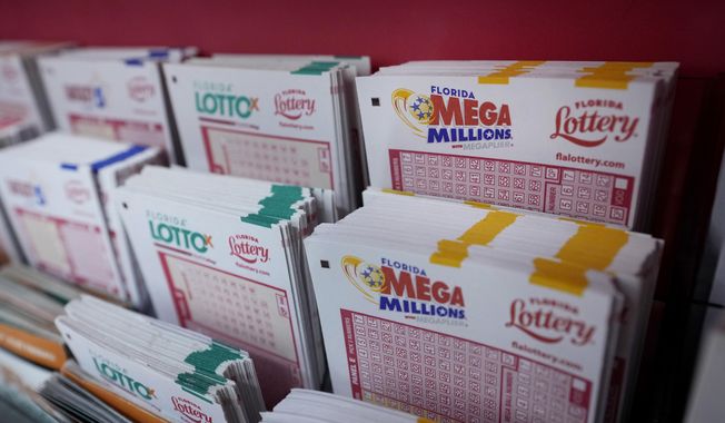 Lottery forms are shown, Monday, Aug. 7, 2023, at the Presidente Supermarket in the Little Havana neighborhood of Miami. Mega Millions jackpot has grown to $1.55 billion, making it the third-largest ever ahead of Tuesday night&#x27;s drawing. (AP Photo/Wilfredo Lee)
