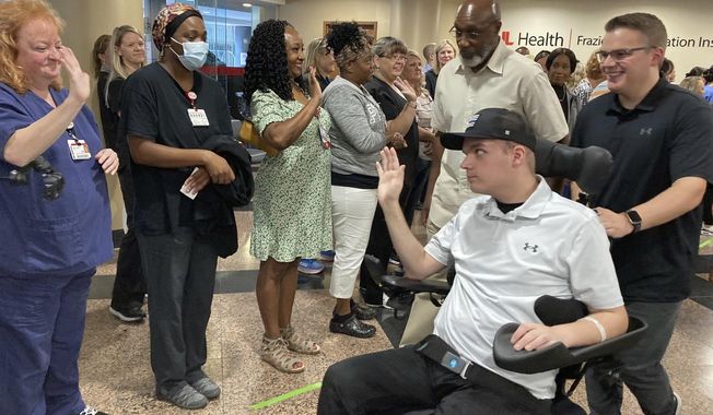 Louisville police officer Nickolas Wilt leaves a medical rehabilitation center in Louisville, Ky., on Friday, July 28, 2023. Wilt has received months of medical care since being critically wounded in a Louisville bank shooting in April. (AP Photo/Bruce Schreiner)