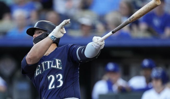 Seattle Mariners&#x27; Ty France hits an RBI single during the first inning of a baseball game against the Kansas City Royals Wednesday, Aug. 16, 2023, in Kansas City, Mo. (AP Photo/Charlie Riedel)