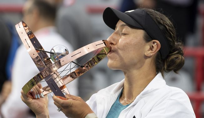 Jessica Pegula, of the United States, kisses the trophy following her win over Liudmila Samsonova, of Russia, in the women&#x27;s final of the National Bank Open tennis tournament in Montreal, Sunday, Aug. 13, 2023. (Christinne Muschi/The Canadian Press via AP)