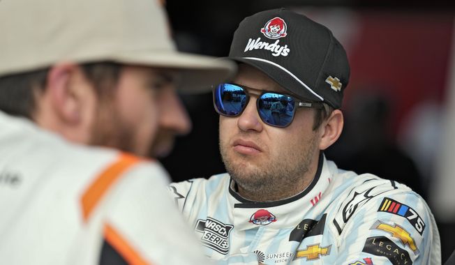 Noah Gragson, right, talks to Corey LaJoie after a practice for the NASCAR Daytona 500 auto race Saturday, Feb. 18, 2023, at Daytona International Speedway in Daytona Beach, Fla. Gragson has been suspended indefinitely by NASCAR and Legacy Motor Club due to undisclosed activity on social media. (AP Photo/Chris O&#x27;Meara, File)