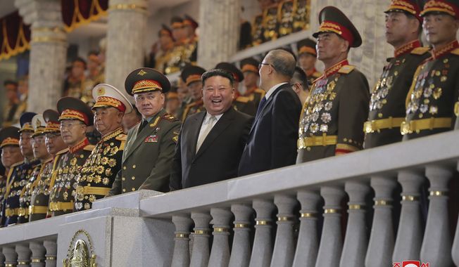 In this photo provided by the North Korean government, North Korean leader Kim Jong Un, center, talks with China&#x27;s Vice Chairman of the standing committee of the country’s National People’s Congress Li Hongzhong, fourth right, as they and Russian Defense Minister Sergei Shoigu, sixth right, attend a military parade to mark the 70th anniversary of the armistice that halted fighting in the 1950-53 Korean War, on Kim Il Sung Square in Pyongyang, North Korea Thursday, July 27, 2023. Independent journalists were not given access to cover the event depicted in this image distributed by the North Korean government. The content of this image is as provided and cannot be independently verified. Korean language watermark on image as provided by source reads: &quot;KCNA&quot; which is the abbreviation for Korean Central News Agency. (Korean Central News Agency/Korea News Service via AP)