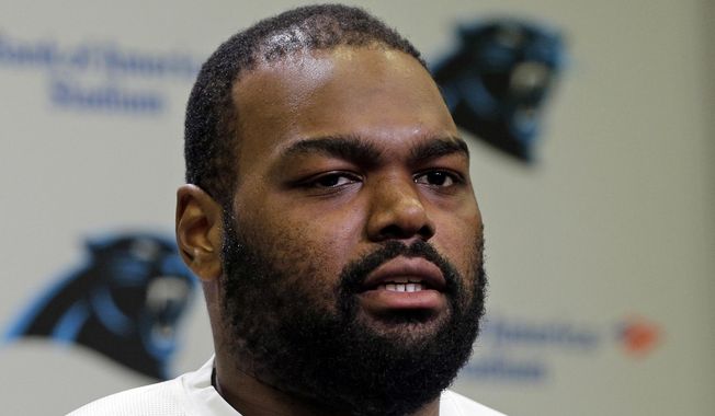 Carolina Panthers&#x27; Michael Oher speaks to the media during the first day of their NFL football offseason conditioning program in Charlotte, N.C., April 20, 2015. Oher, the former NFL tackle known for the movie “The Blind Side,” filed a petition Monday, Aug. 14, 2023, in a Tennessee probate court accusing Sean and Leigh Anne Tuohy of lying to him by having him sign papers making them his conservators rather than his adoptive parents nearly two decades ago.(AP Photo/Chuck Burton, File) **FILE**