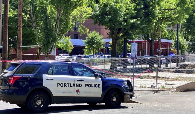 Portland Police respond to a shooting at the Legacy Good Samaritan Medical Center in Portland, Ore., Saturday, July 22, 2023. Gunfire erupted in a maternity unit of the Oregon hospital over the weekend, fatally wounding an unarmed security guard and leading to renewed calls Monday, July 24, to protect health care workers from increasing violence. (Maxine Bernstein/The Oregonian via AP)