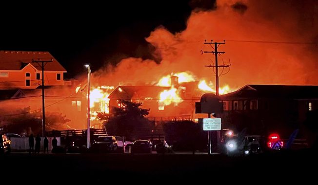 An oceanfront rental house is engulfed in fire, Friday, Aug. 11, 2023 in Kill Devil Hills, N.C. Mulitple people thought to be vacationing in North Carolina&#x27;s Outer Banks died early Friday morning in a fatal house fire, city officials said Friday.(Kari Pugh/The Virginian-Pilot via AP)