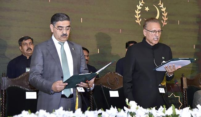 In this photo released by Pakistan&#x27;s President Office, President Arif Alvi, right, administrates oath from Anwaar-ul-Haq Kakar as caretaker Prime Minister during a ceremony, in Islamabad, Pakistan, Monday, Aug. 14, 2023. Kakar was sworn in as the country&#x27;s prime minister to head a caretaker national government that will oversee parliamentary elections amid one of the worst economic crises the Islamic nation has faced, officials said. (Pakistan President Office vis AP)