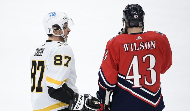 Pittsburgh Penguins center Sidney Crosby (87) talks with Washington Capitals right wing Tom Wilson (43) during the second period of an NHL hockey game, Feb. 23, 2021, in Washington. After lengthy playoff streaks ended, the Penguins and Capitals are making moves to get back in the mix now. The Capitals re-signed Wilson for $45.5 million over seven years. Wilson turns 30 before his new deal starts. The deal doesn’t make Washington any younger, and it&#x27;s a significant gambles for an older team that has won the Stanley Cup and are trying to keep contending. Penguins captain Sidney Crosby celebrated his 36th birthday Monday, and Capitals counterpart and longtime rival Alex Ovechkin turns 38 next month. (AP Photo/Nick Wass, file) **FILE**