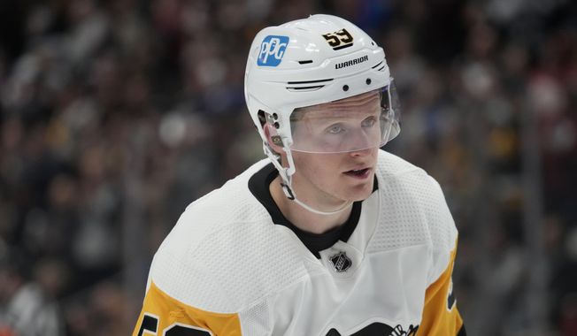 Pittsburgh Penguins left wing Jake Guentzel (59) in the second period of an NHL hockey game Wednesday, March 22, 2023, in Denver. Guentzel underwent right ankle surgery on Wednesday, Aug. 2, 2023, and will miss at least three months. (AP Photo/David Zalubowski, File)