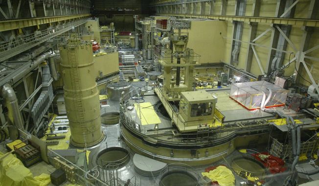 A plastic tent, right, covers a cleaning apparatus in Reactor Block 2 of the Paks Nuclear Power Plant to catch a small amount of still leaking radioactive gas in Paks, Hungary, about 90 kilometers (56 miles) south of Budapest on Tuesday, April 22, 2003. Hungary, which maintains close ties to Russia, is fully dependent on Moscow to provide fuel for its four-reactor nuclear power plant. (Tibor Illyes/MTI via AP, File)