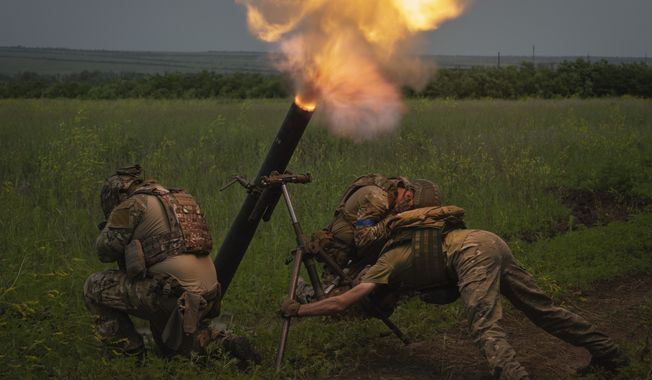 Ukrainian soldiers fire toward Russian positions on the frontline in Zaporizhzhia region, Ukraine, Saturday, June 24, 2023. Battles are also raging along the southern front in Zaporizhzhia, where Ukrainian forces are making minimal gains and coming up against formidable Russian fortifications. (AP Photo/Efrem Lukatsky, File)