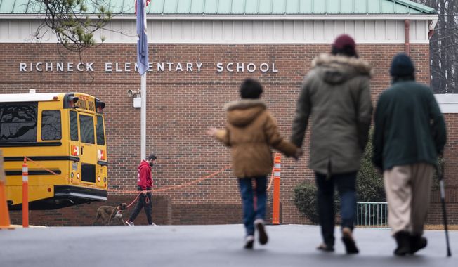 Students return to Richneck Elementary in Newport News, Va., on Jan. 30, 2023. The mother a 6-year-old who shot his teacher in Virginia is expected to plead guilty Tuesday, Aug. 15, 2023, seven months after her son used her handgun in the classroom shooting.  (Billy Schuerman/The Virginian-Pilot via AP)