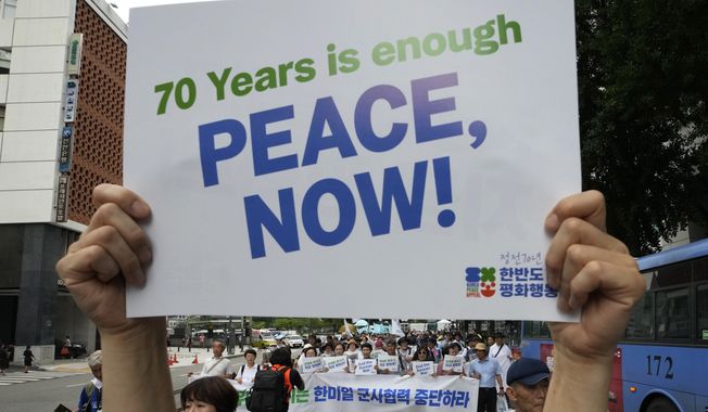 Participants march during a rally for peace unification of the Korean peninsula in Seoul, South Korea, Saturday, July 22, 2023. Hundreds attended the rally commemorating the 70th anniversary of the Korean War Armistice Agreement that ended the Korean War on July 27, 1953. (AP Photo/Ahn Young-joon)